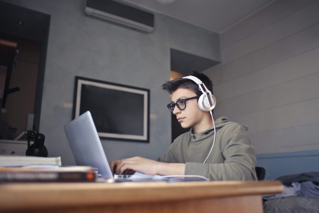 young boy studies in his room